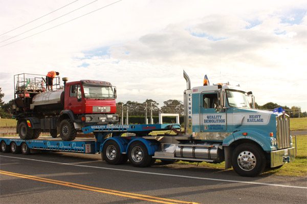 Seed on Earth hydroseeding truck being transported on a low loader