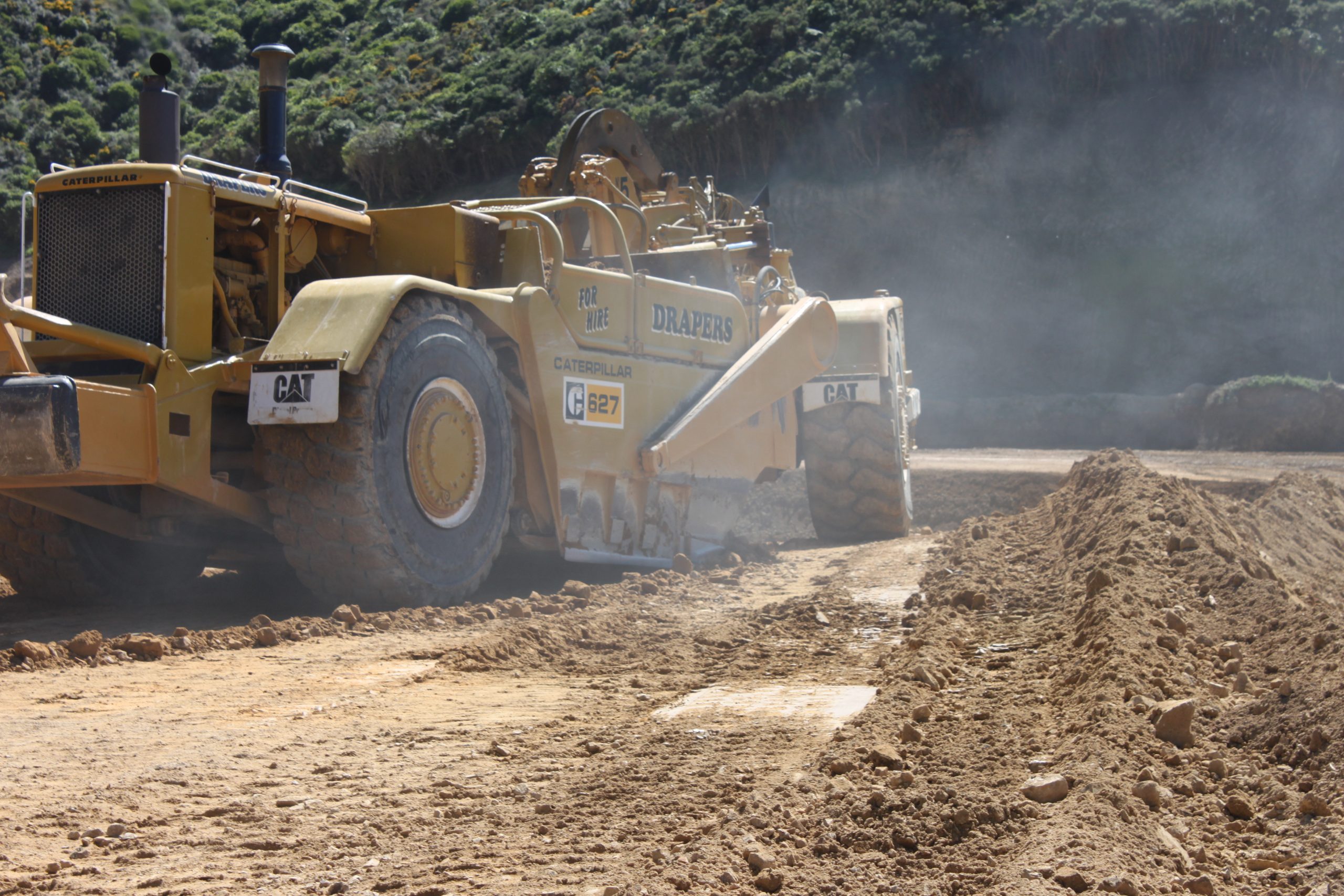 Motor scraper working on bulk earthworks