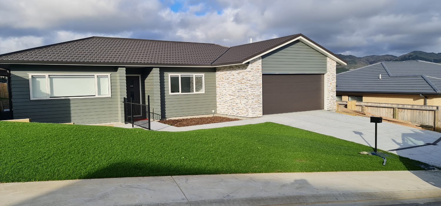 Even green hydroseeded lawn in front of a newly built house