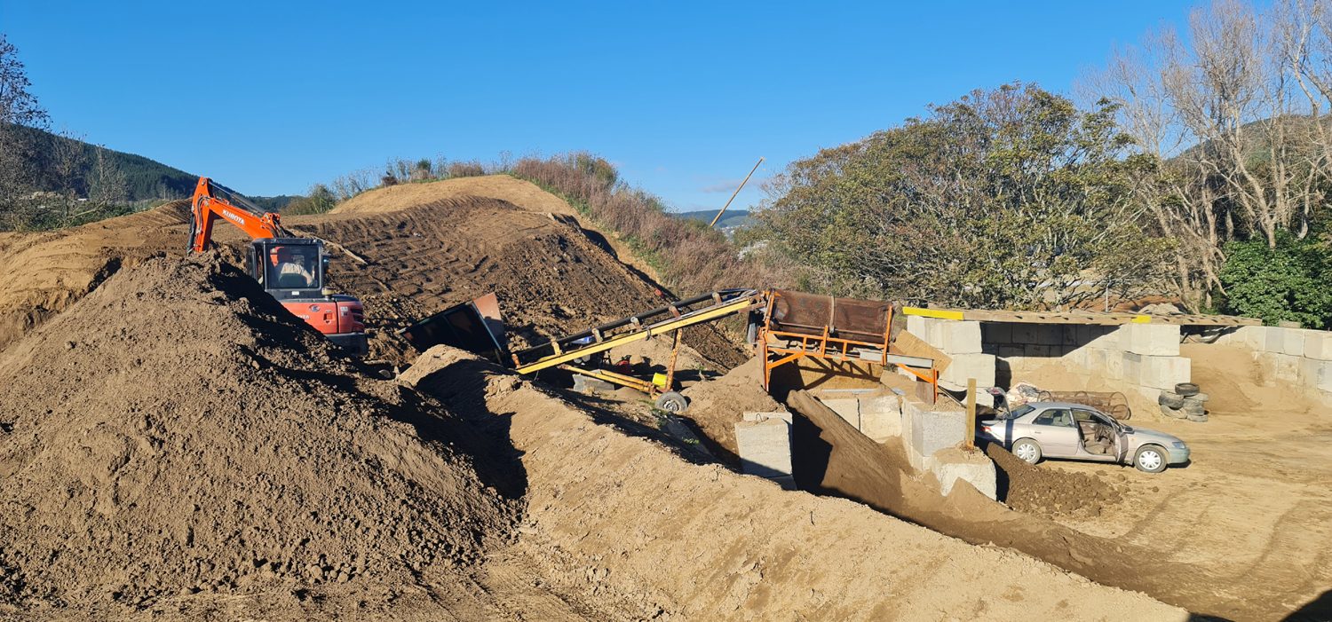 Screened soil stockpiles beside the screening plant