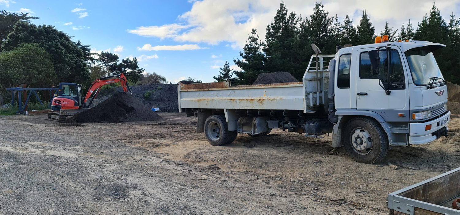Tipper truck and excavator at the topsoil yard